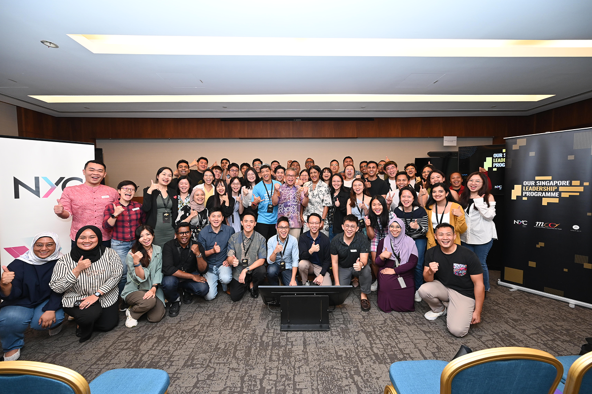Group photo in front of two NYC standees with Minister Edwin Tong.